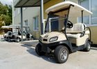 Electric golf car parked on parking near hotel building